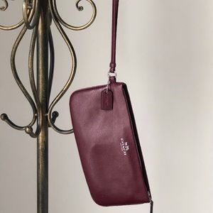 • Coach Oxblood Wristlet with zipper closure •